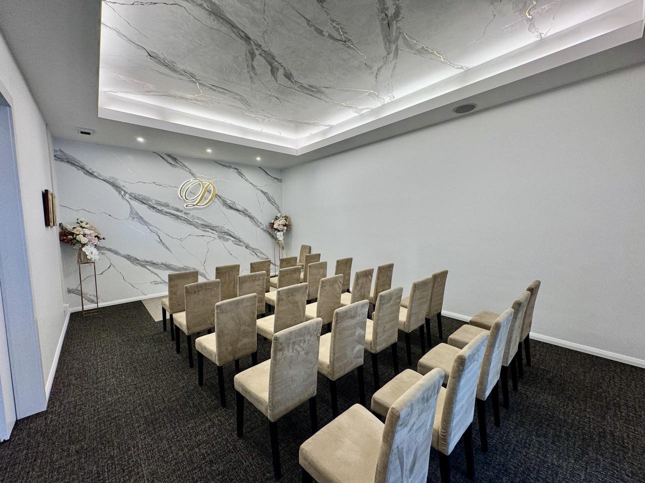 Interior view of the serene chapel at Divine Family Funerals, featuring rows of seats and soft, ambient lighting.